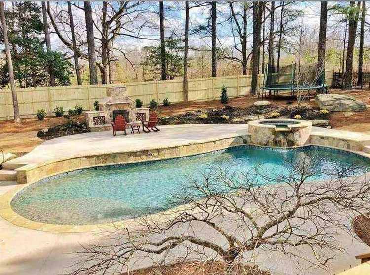 Custom freeform pool design with spa and outdoor fireplace Georgia