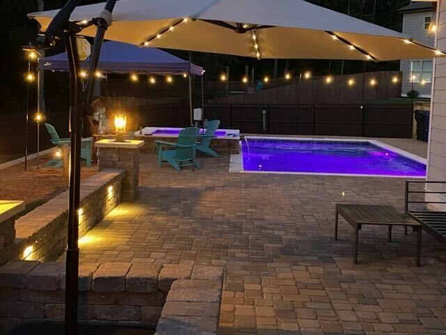 Pool design with purple LED lighting at night Georgia