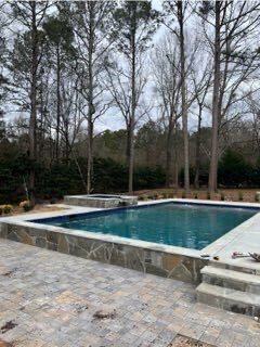 Rectangular pool design with stone coping Georgia